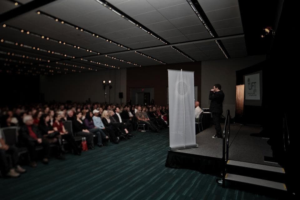 A young Dr. Alain Desaulniers speaking to an audience